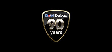 Black and silver Mobil Delvac 90 years sign for diesel engine history