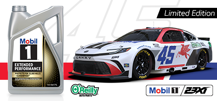 Tyler Reddick is seen behind his #45 car, a white Toyota Camry with blue numbering and a red Pegasus logo, with a superimposed bottle of Mobil 1 Extended Performance motor oil to the left-hand side.
