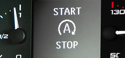 Close up of the start stop system icons on a car dashboard