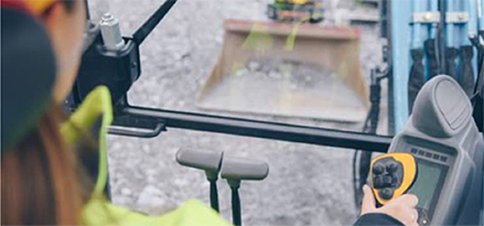 Woman operating excavator view from inside cab