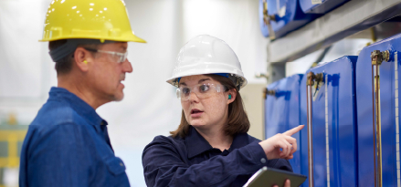 Engineers with hard hats discussing