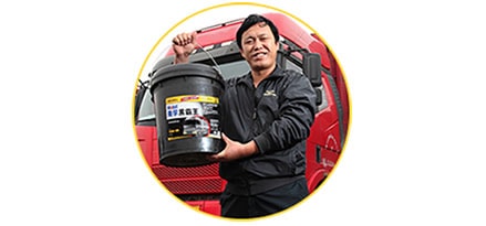 Engineer with Mobil Delvac oil in front of truck