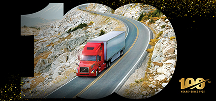 Red truck driving down highway in black 100 frame 