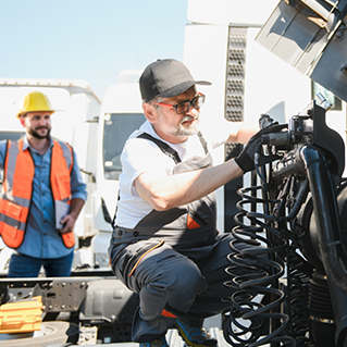 Engineer in black hat assessing engine