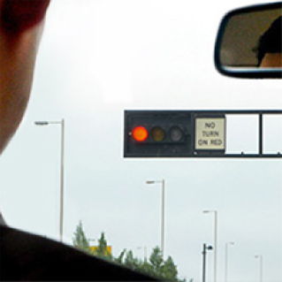Driver of a car with a start stop system at a red light