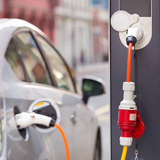 Hybrid vehicle plugged into a charging station