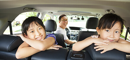 Two girls looking out of open SUV liftgate