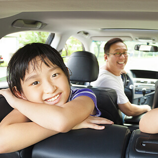 Two girls looking out of open SUV liftgate