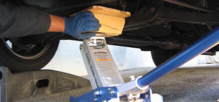 Secure engine on jack with blocks of wood