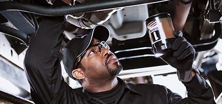 Engineer installing an oil filter