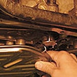 Mechanic cleans gasket surface with solvent