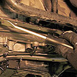 Mechanic loosens bolts on transmission pan