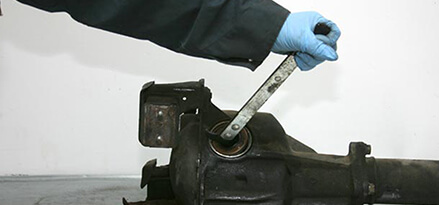 Pry the old axle seal out of the differential or transmission