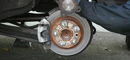 Putting replacement CV axle into place
