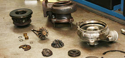 Turbocharger disassembled with parts on a table