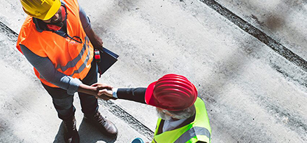 two Mobil workers shaking hands