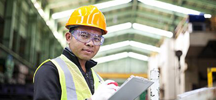 Mobil worker looking at a clipboard