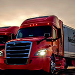 Truck labeled for Nussbaum Transportation with red cab on road