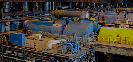 Three power generation turbines in a pristine facility.