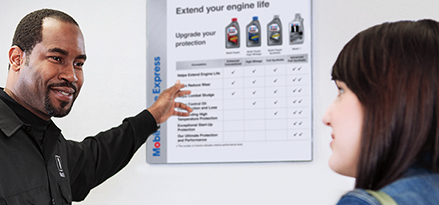 Mobil 1 Lube Express℠ technician explains to customer different types of engine oil