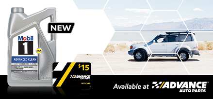 A bottle of Mobil 1 Advanced Clean motor oil and a $15 Advance Auto Parts gift card appear on the left. On the right is a white SUV driving on sand with a lake and a mountain in the background