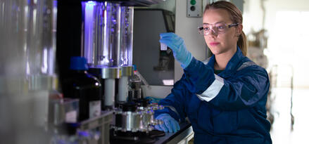 Laboratory technician conducting equipment testing and analysis.