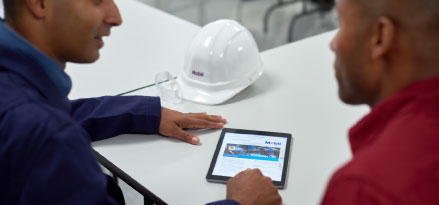 Mobil engineers using a tablet