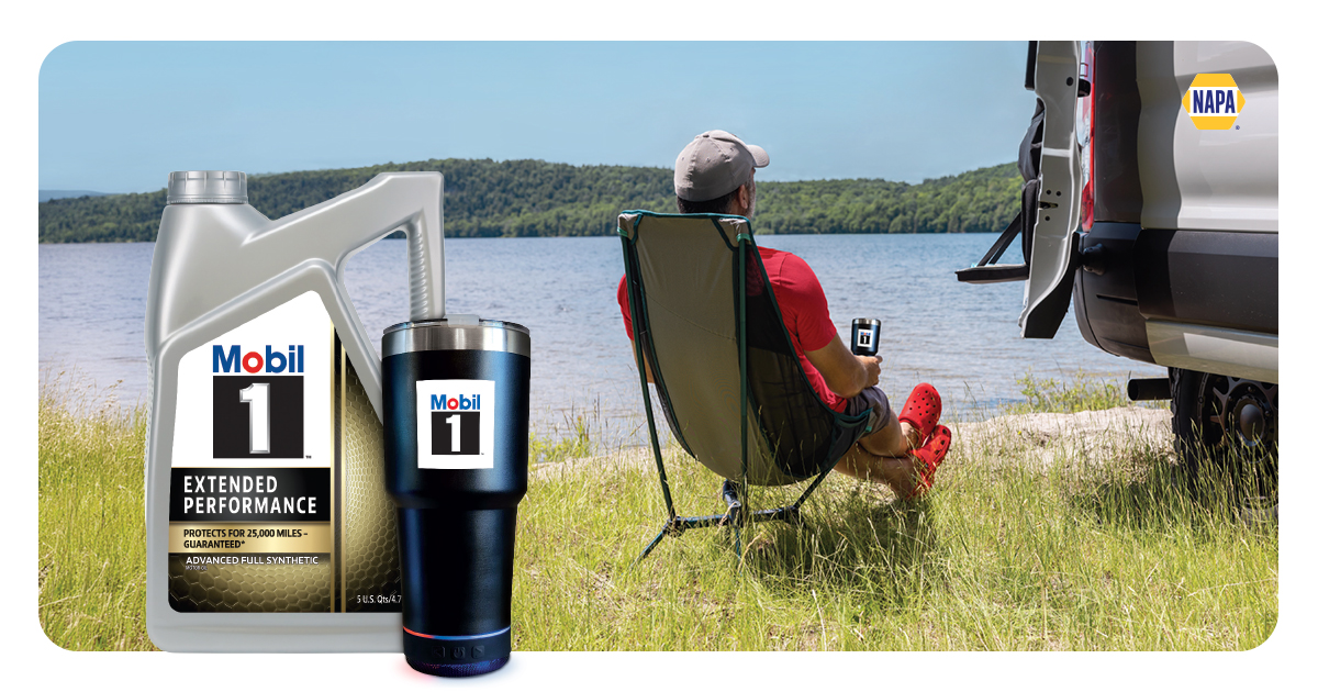 A man relaxes in a camping chair beside a lake