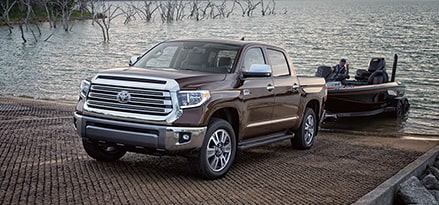 brown pickup truck pulling boat