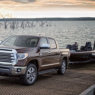 brown pickup truck pulling boat