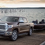 brown pickup truck pulling boat