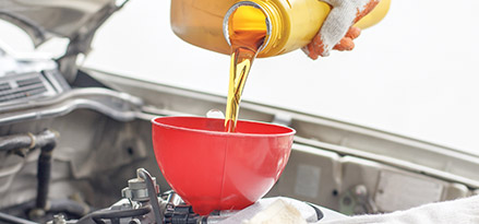 Mechanic pouring Oil in engine