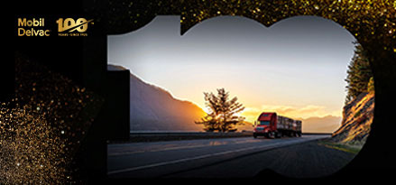 Red truck in the road with the sunset behind