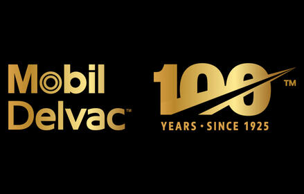 Gold Mobil Delvac logo alongside a gold ‘100 years since 1925’ anniversary emblem on a black background